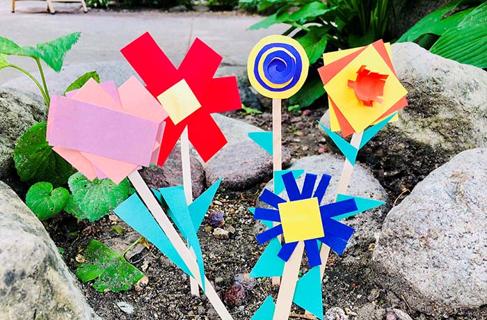 Geometric flowers made from paper and wooden sticks